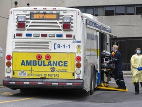 Paramedics bring gurneys to the multi-patient transport at Kingston General Hospital after dropping off COVID-19 patients from the GTA area, in Kingston, Ont., on Thursday Apr. 22, 2021.