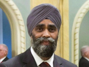 National Defence Minister Harjit Sajjan is seen during a group photo after being sworn in Wednesday, Nov.4, 2015 in Ottawa.