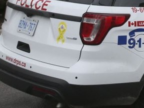 Durham Police brass have reversed an order that yellow 'Support Our Troops' ribbon decals be taken off the force's cruisers.