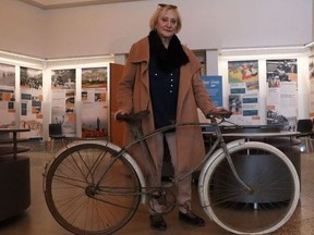 Marie-Claude Halot poses with the bicycle given to her father, Christian Costil, by Canadian soldier Marius Aube shortly after he landed at Juno Beach on D-Day.
