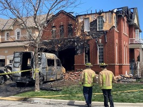 A neighbour rescued a family from a second-floor balcony after a home caught fire in Newmarket.