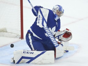 A puck deflects off the shoulder of Toronto Maple Leafs David Rittich during the second period in Toronto on Tuesday April 13, 2021.