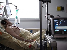 A patient infected with COVID-19 is cared by extracorporeal membrane oxygenation in the COVID-19 reanimation unit at the AP-HP Georges Pompidou European Hospital in Paris, Tuesday, April 6, 2021.