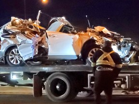 The aftermath of a vehicle being hit by a falling overhead road sign on the QEW in Burlington on Tuesday, April 27, 2021.