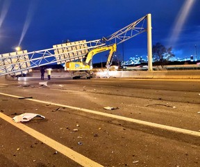 An excavator that knocked down an overhead road sign on the QEW in Burlington, killing a passing motorist, on Tuesday, April 27, 2021.