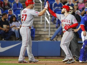 Los Angeles Angels centre fielder Mike Trout (left) meets first baseman Jared Walsh during Friday's win over the Toronto Blue Jays.