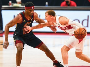 Raptors' Malachi Flynn (right) drives past Cleveland Cavaliers' Damyean Dotson during the first quarter at Amalie Arena in Tampa, Fla., on Monday, April 26, 2021.