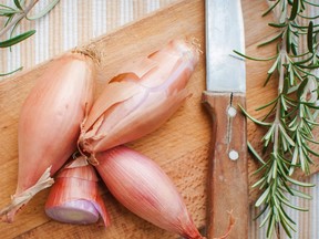 Shallots on cutting board with fresh rosemary