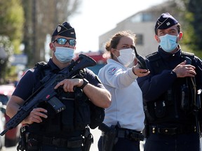 Police officers secure the area where an attacker stabbed a female police administrative worker, in Rambouillet, France, April 23, 2021.