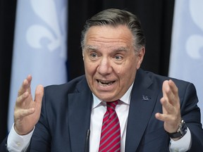 Quebec Premier Francois Legault responds to reporters questions during a news conference on the COVID-19 pandemic, Tuesday, March 23, 2021 at the legislature in Quebec City.