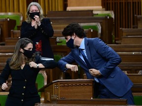 Finance Minister Chrystia Freeland and Prime Minister Justin Trudeau bump elbows after she delivered the federal budget in the House of Commons in Ottawa on Monday, April 19, 2021.
