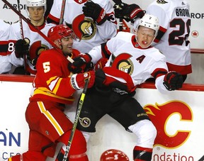 Flames defenceman Mark Giordano slams into Senators winger Brady Tkachuk in a recent game. Despite never being drafted, Giordano has enjoyed an excellent career. DARREN MAKOWICHUK/POSTMEDIA
