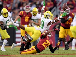 Jevon Holland of the Oregon Ducks breaks up a pass to Tyler Vaughns (21) of the USC Trojans.