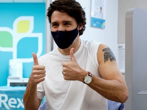 Prime Minister Justin Trudeau reacts after being inoculated with AstraZeneca's vaccine against COVID-19 at a pharmacy in Ottawa, April 23, 2021.