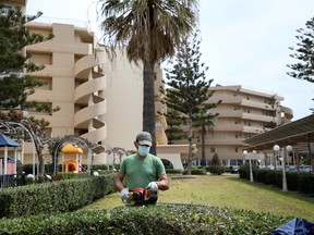 A gardener wearing a protective face mask trims a fence at the Sun Beach Resort, amid the coronavirus disease (COVID-19) pandemic, on the island of Rhodes, Greece, April 14, 2021.