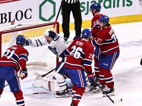 Toronto Maple Leafs left wing Zach Hyman (11) celebrates a Toronto Maple Leafs center John Tavares (91) (not pictured) goal against Montreal Canadiens goaltender Jake Allen (34) during the second period at Bell Centre April12, 2021.