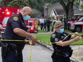 Police officials cordon off a street in southwest Houston, Texas, April 30, 2021.