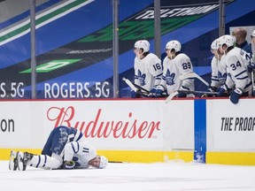 The Leafs’ Zach Hyman lies on the ice after colliding with Canucks’ Alexander Edler during their game in Vancouver on Sunday night.  Darryl Dyck/THE CANADIAN PRESS