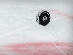 A view of a puck and the NHL logo and the face-off circle before the game between the Dallas Stars and the Detroit Red Wings at the American Airlines Center.