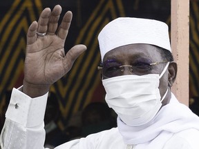 Chadian President Idriss Deby Itno greets a crowd of journalists and supporters as he arrives to cast his ballot at a polling station in N'djamena, on April 11, 2021.