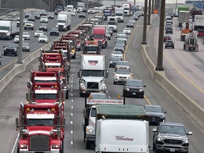 A convoy of dump trucks moves east in the express lanes of the 401 as part of a protest on Thursday, April 15 2021