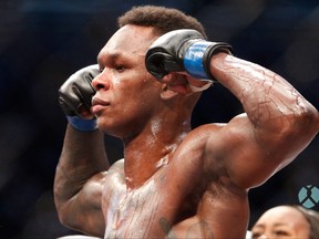 This file photo taken on Oct. 6, 2019 shows middleweight title winner Israel Adesanya of New Zealand celebrating after defeating Robert Whittaker of Australia during the middleweight title bout of the UFC 243 fight night in Melbourne.