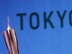 The Olympic torch is seen at Hibarigahara Festival Site, during the last leg of the first day of the Tokyo 2020 Olympic torch relay.