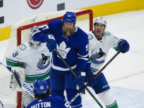 Maple Leafs' Joe Thornton screens Vancouver Canucks goalie Braden Holtby during the first period in Toronto on Thursday, April 29, 2021.