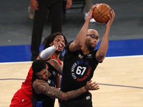 New York Knicks centre Taj Gibson, right,  grabs a rebound against Toronto Raptors forward Freddie Gillespie during the first half of an NBA basketball game Saturday, April 24,2021, in New York.