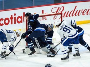 Winnipeg Jets goalie Connor Hellebuyck makes a save against Toronto Maple Leafs forward John Taveres during the second period at Bell MTS Place last night. The Leafs beat the Jets 4-1.  USA TODAY Sports