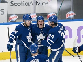 Maple Leafs' Mitchell Marner (centre) celebrates with Auston Matthews (right) after scoring a goal against the Ottawa Senators during the second period at Scotiabank Arena on Saturday, April 10.