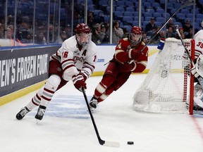 Now a defenceman with the Colorado Avalanche, Canadian  Cale Makar (left) of the Massachusetts Minutemen carries the puck against the Denver Pioneers during the semifinals of the NCAA Men's Frozen Four tournament in Buffalo in 2019. This year's semifinals begin Thursday.