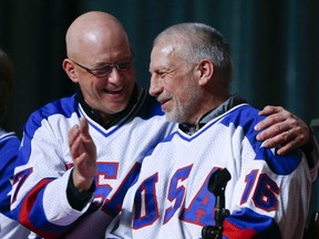 In this Feb. 21, 2015, file photo, Jack O'Callahan, left, and Mark Pavelich of the 1980 U.S. hockey team talk during a "Relive the Miracle" reunion at Herb Brooks Arena in Lake Placid, N.Y.