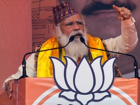 Indian Prime Minister Narendra Modi gestures as he speaks in a rally during the ongoing Phase 4 of West Bengal's assembly election, at Kawakhali on the outskirts of Siliguri on April 10, 2021.