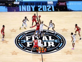 Reggie Chaney (32) of the Houston Cougars and Flo Thamba (0) of the Baylor Bears compete for the opening tip-off during the 2021 NCAA Final Four semifinal at Lucas Oil Stadium in Indianapolis, Saturday, April 3, 2021.