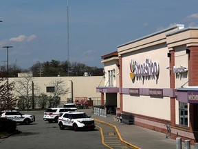 Police cars are seen on the site of a shooting, at a Stop and Shop grocery store, in West Hempstead, New York, April 20, 2021.