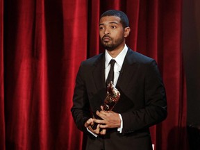 A handout photo received from BAFTA shows British actor Noel Clarke posing with the award for the Outstanding British Contribution to Cinema, during the BAFTA British Academy Film Awards 'Opening Night' at the Royal Albert Hall in London on April 10, 2021.