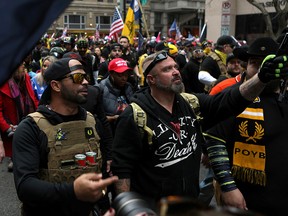 Proud Boys members Enrique Tarrio, left, and Joe Biggs march during a December 12, 2020 protest in Washington, D.C.