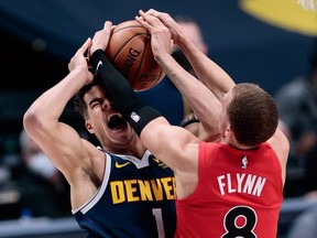 Denver Nuggets forward Michael Porter Jr. (1) is fouled while driving to the net against Toronto Raptors guard Malachi Flynn at Ball Arena on April 29, 2021.