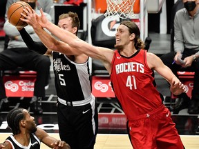 LA Clippers guard Luke Kennard (5) grabs a rebound away from Houston Rockets forward Kelly Olynyk (41 at Staples Center.