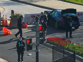 Law enforcement officers collect evidence at the site after a car rammed a police barricade outside the U.S. Capitol building on Capitol Hill in Washington, April 2, 2021.