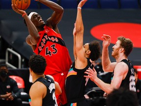 Raptors' Pascal Siakam shoots over Spurs' Derrick White and others during the first quarter at Amalie Arena in Tampa, Fla. on Wednesday, April 14, 2021.