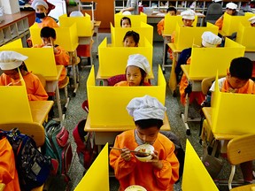 Students eat their lunch on desks with plastic partitions as a preventive measure to curb the spread of COVID-19 at Dajia Elementary School in Taipei on April 29, 2020. 



Students eat their lunch on desks with plastic partitions as a preventive measure to curb the spread of the COVID-19 coronavirus at Dajia Elementary School in Taipei on April 29, 2020. (Photo by Sam Yeh / AFP) (Photo by SAM YEH/AFP via Getty Images)