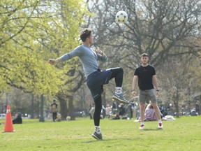 Social distancing and playing soccer at Trinity Bellwoods Park on Friday, April 23, 2021.