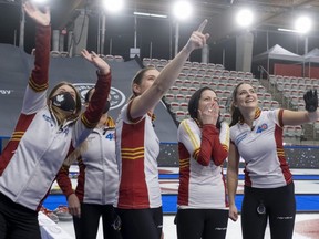 Masked-up coach Heather Nedohin (left) with the Scotties Tournament of Hearts gold medal-winning Kerri Einarson rink in Calgary, Feb. 28, 2021.