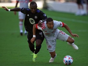CF Montreal defender Zachary Brault-Guillard (left) and Toronto FC defender Justin Morrow tangle up while battling for the ball during the second half at DRV PNK Stadium in Fort Lauderdale, Fla., yesterday. USA TODAY Sports