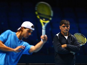 Rafael Nadal of Spain in action as coach and uncle Toni Nadal watches on in a practice session during the Barclays ATP World Tour Finals - previews at O2 Arena on Nov. 21, 2009 in London.