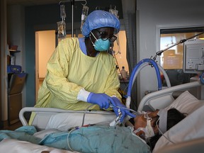 Registered nurse Jane Abas tends to a COVID-19 variant patient who is intubated and on a ventilator in the intensive care unit at the Humber River Hospital during the COVID-19 pandemic in Toronto on Tuesday, April 13, 2021.