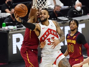 Toronto Raptors guard Gary Trent Jr., centre, drives to the basket against Cleveland Cavaliers guard Collin Sexton, left, during the fourth quarter at Rocket Mortgage FieldHouse in Cleveland, Ohio, April 10, 2021.