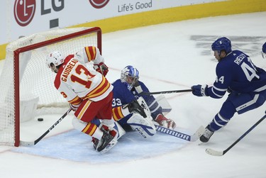 Calgary Flames Johnny Gaudreau LW (13) beats Toronto Maple Leafs David Rittich G (33) for the winning goal during the OT in Toronto on Tuesday April 13, 2021. Jack Boland/Toronto Sun/Postmedia Network